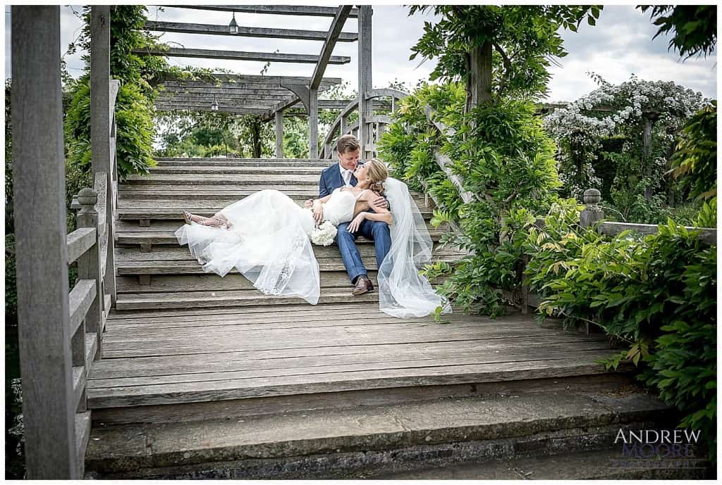 beautiful wedding couple at great fosters over bridge